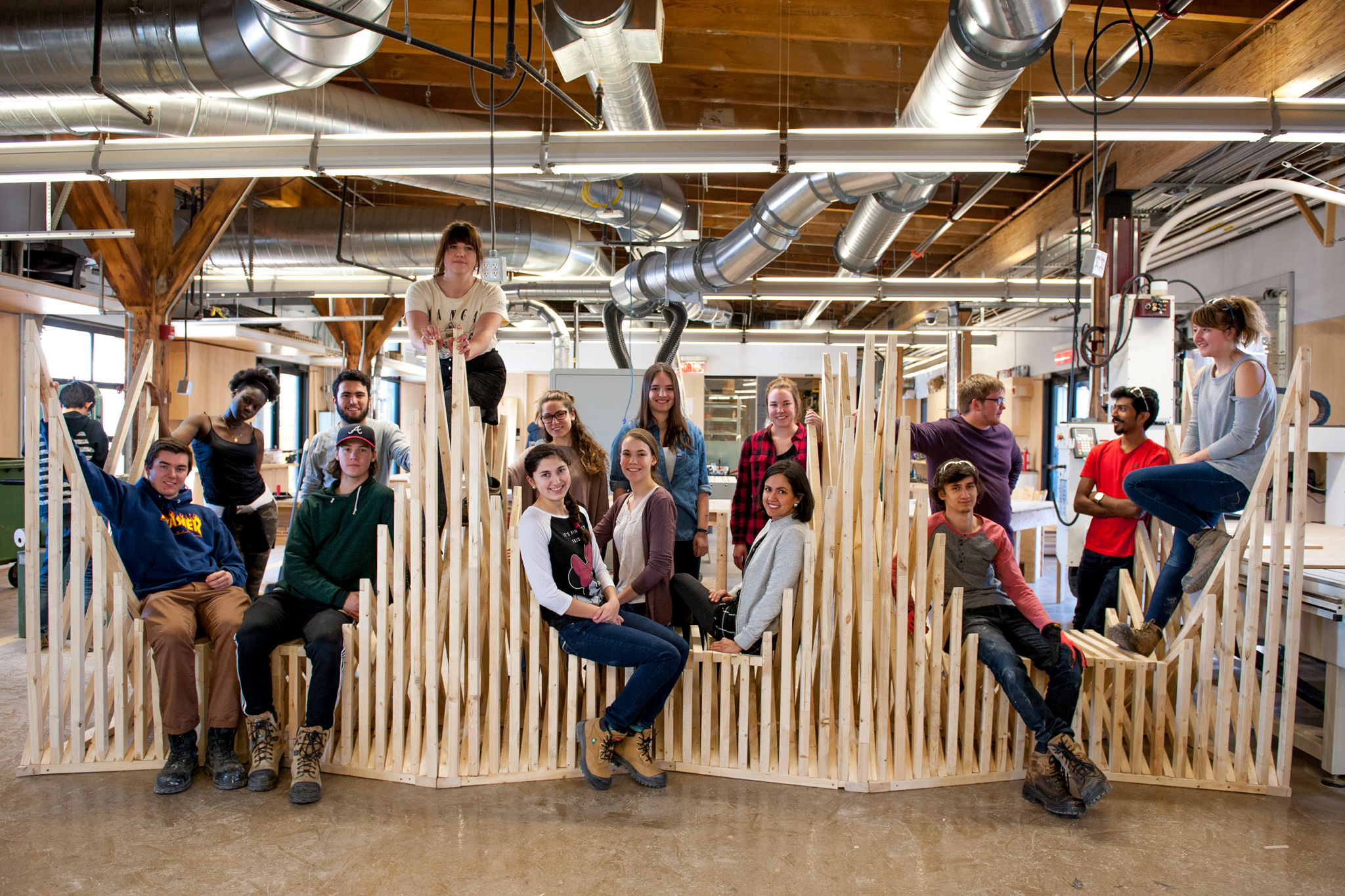 Students around a wooden structure 